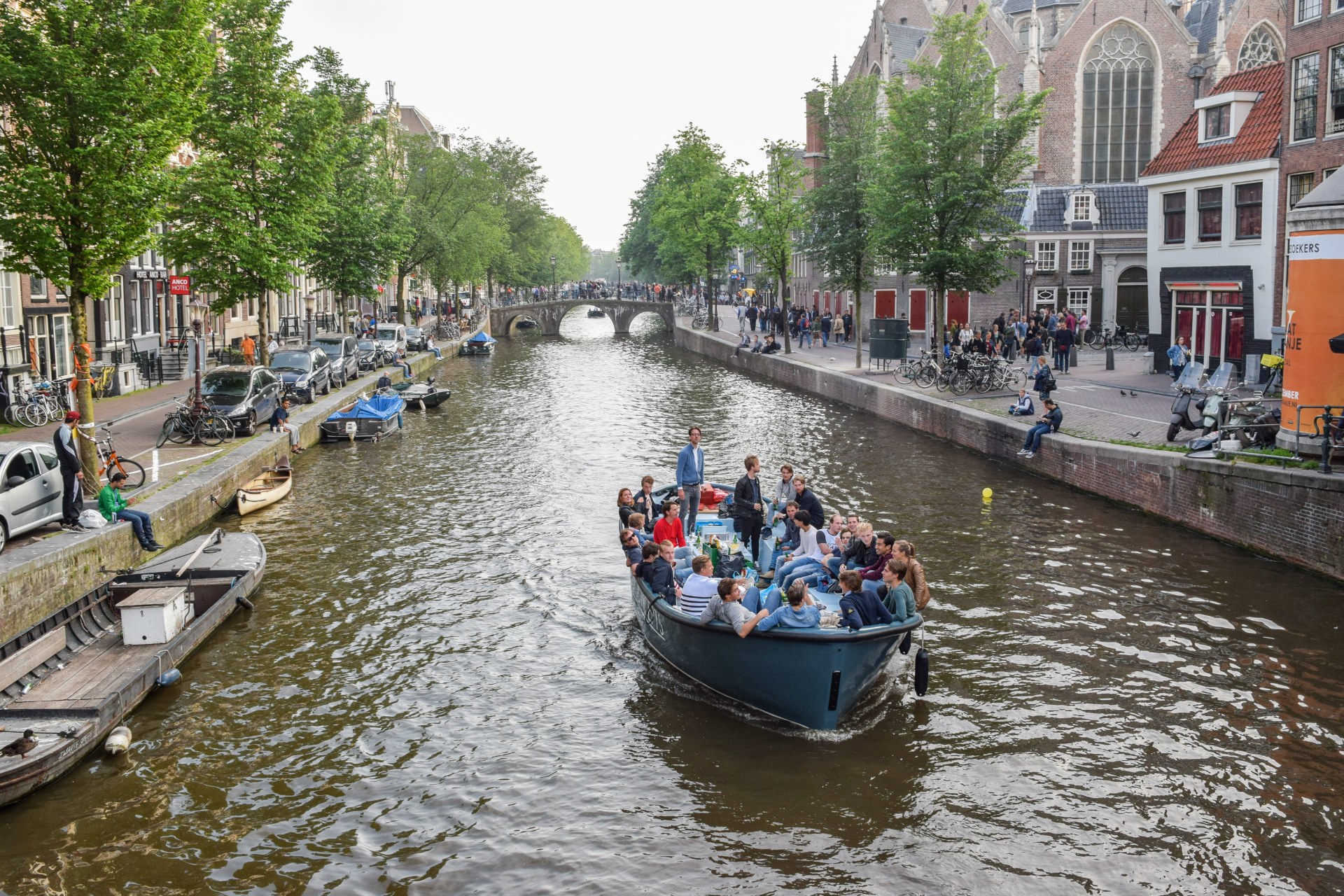 Jóvenes en un barco por un canal de Ámsterdam
